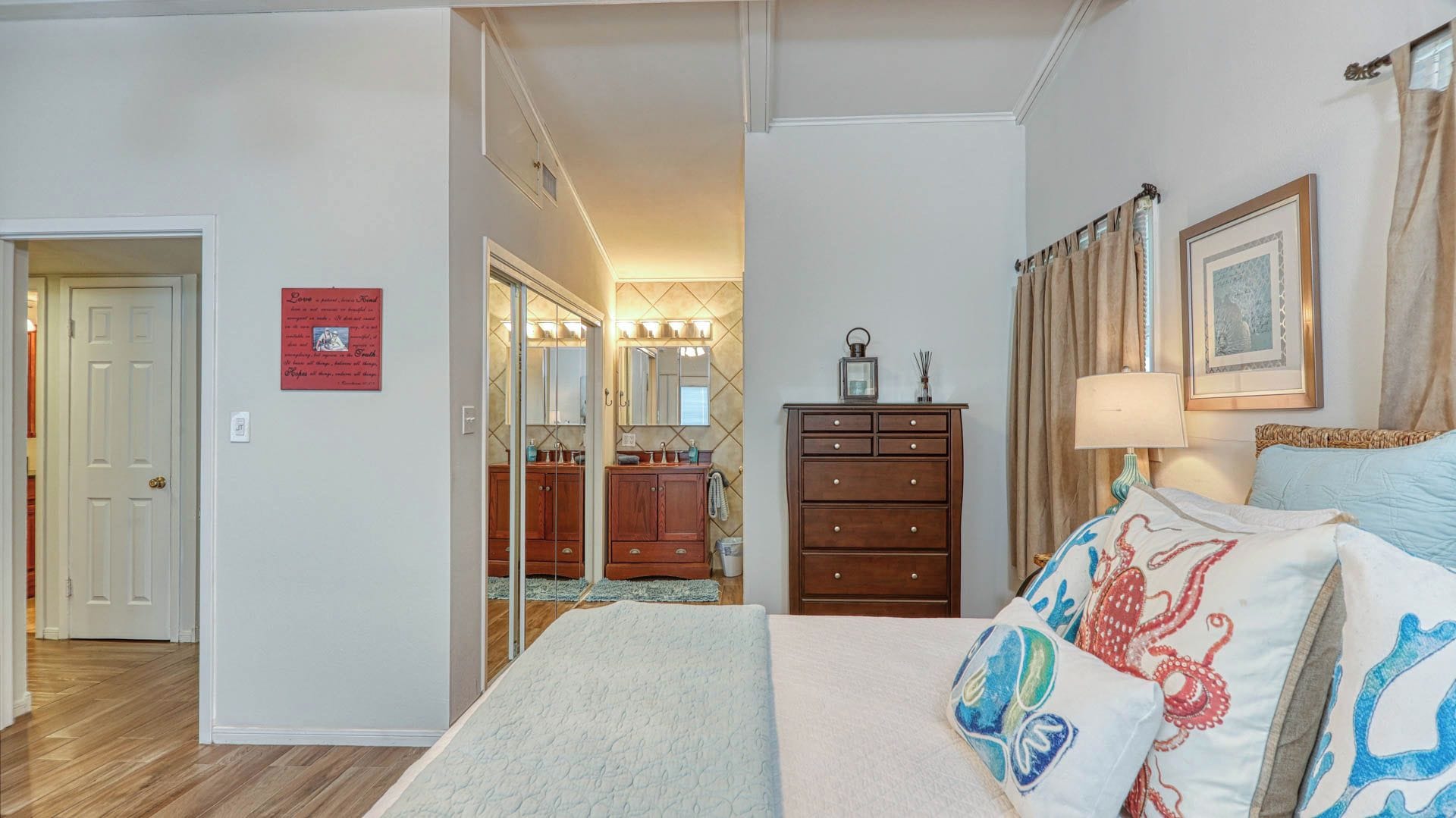 Primary bedroom with an attached vanity area.