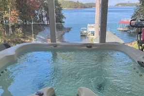 A hot tub with a view of a lake and dock. - Private Dock! Luxury Beachfront Lake Lanier Escape (Buford)