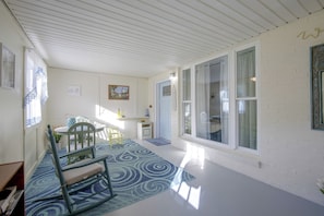 A room with a dining table, chairs, a rug, and a door with a sign. - Harrisburg Unit w/ Mtn Views & Backyard (Harrisburg)