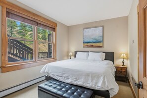 Wake up to fresh mountain air and natural light streaming through your private balcony. Crisp white linens and warm wood accents create a peaceful retreat after a day exploring the slopes. - Keystone Golf Condo with Hot Tub, Private Deck, and Ski Access (Keystone)