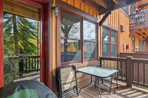 Step onto your private deck and soak in the peaceful forest views through towering evergreens. Enjoy morning coffee or evening relaxation at your outdoor table, surrounded by fresh mountain air and natural beauty. - Keystone Golf Condo with Hot Tub, Private Deck, and Ski Access (Keystone)