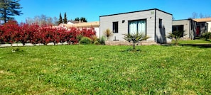 A modern building with a flat roof, a small front porch, and a well-maintained lawn. - New Listing (Saint-Germain-de-Lusignan)