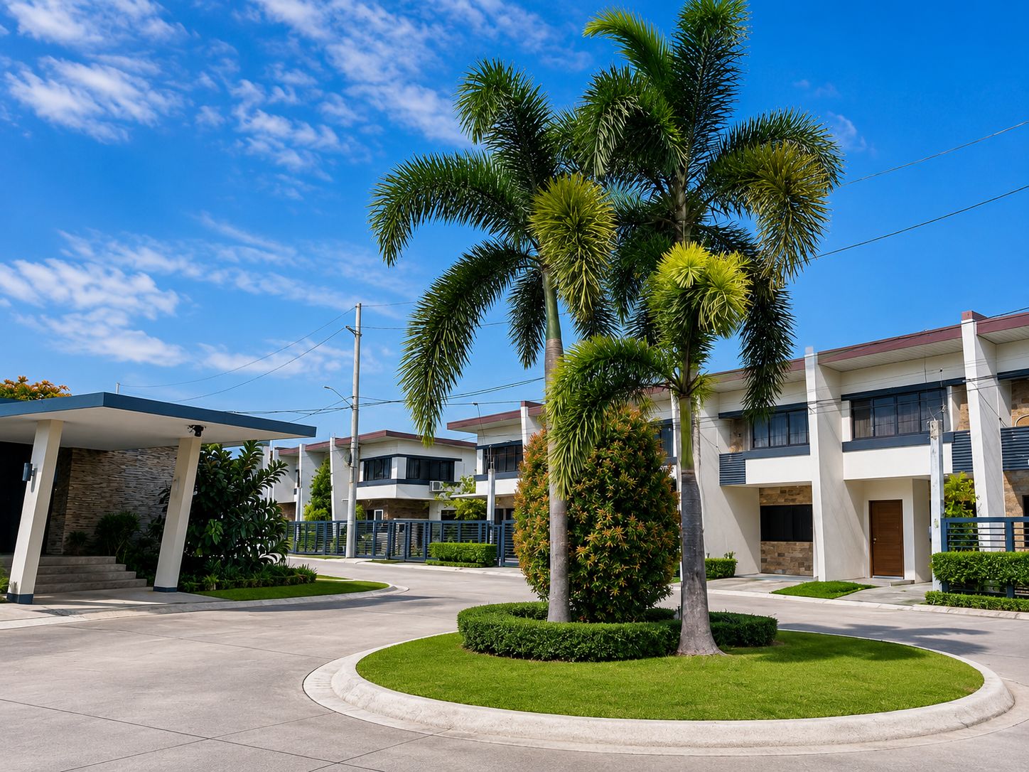 A modern residential building with a covered entrance, a landscaped lawn, and a palm tree.