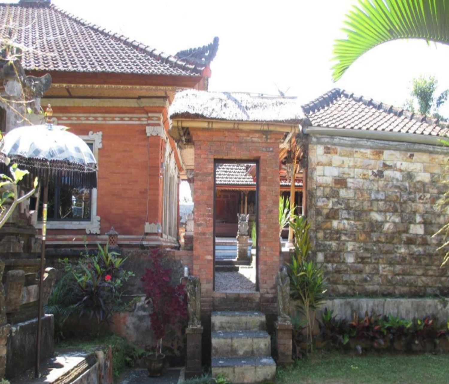 Un edificio tradicional con tejado de tejas, pared de piedra y una pequeña entrada.
