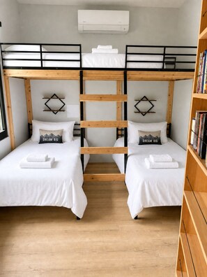 A room with two bunk beds, a wooden floor, a white air conditioning unit, and a bookshelf. - New Spacious Mountain Modern Home • 5 bedroom/5 Bath • Walk Wisp • Sauna/Hot Tub (McHenry)