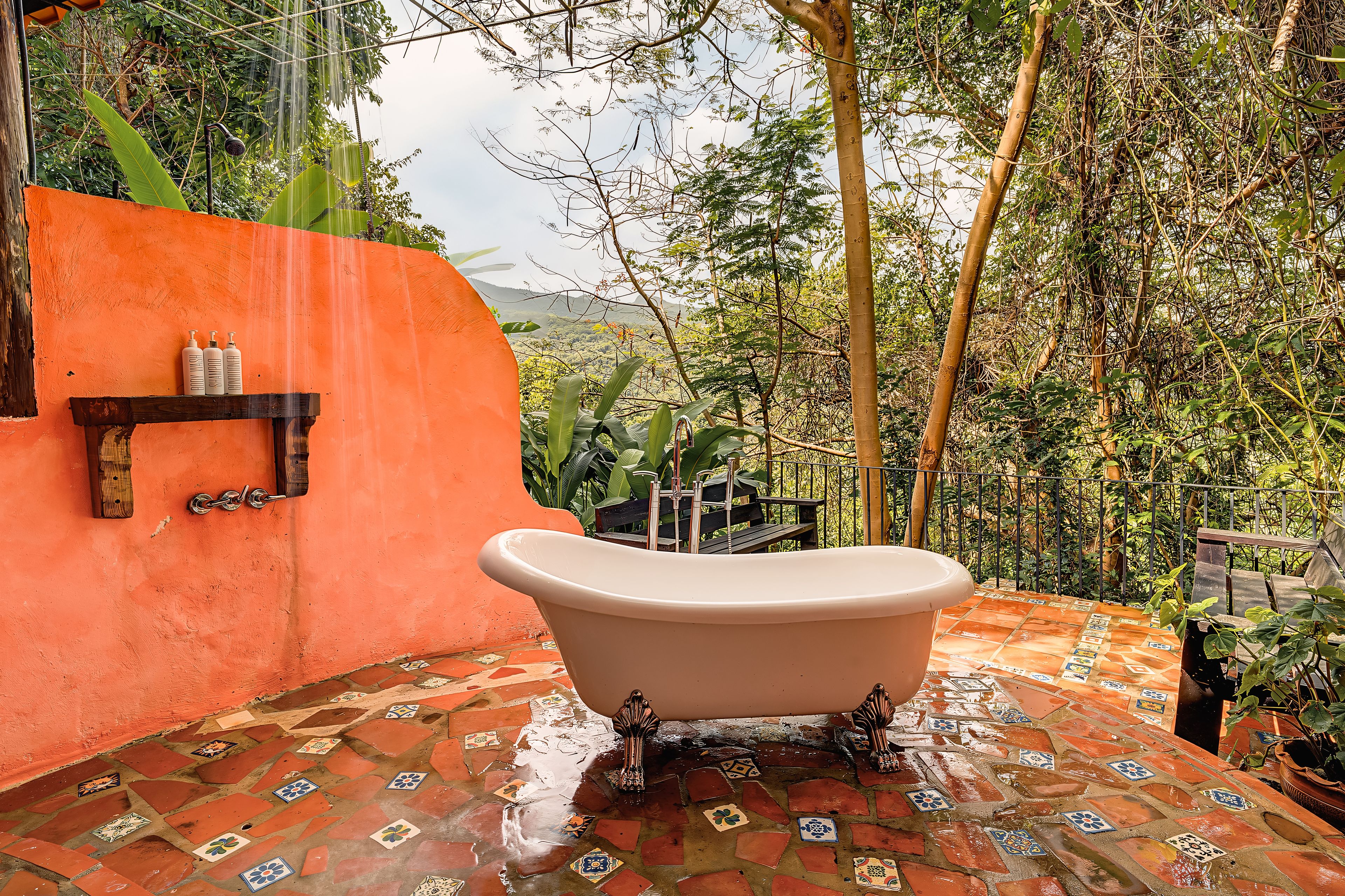 A bathroom with a freestanding bathtub, a shower, and a tiled floor.