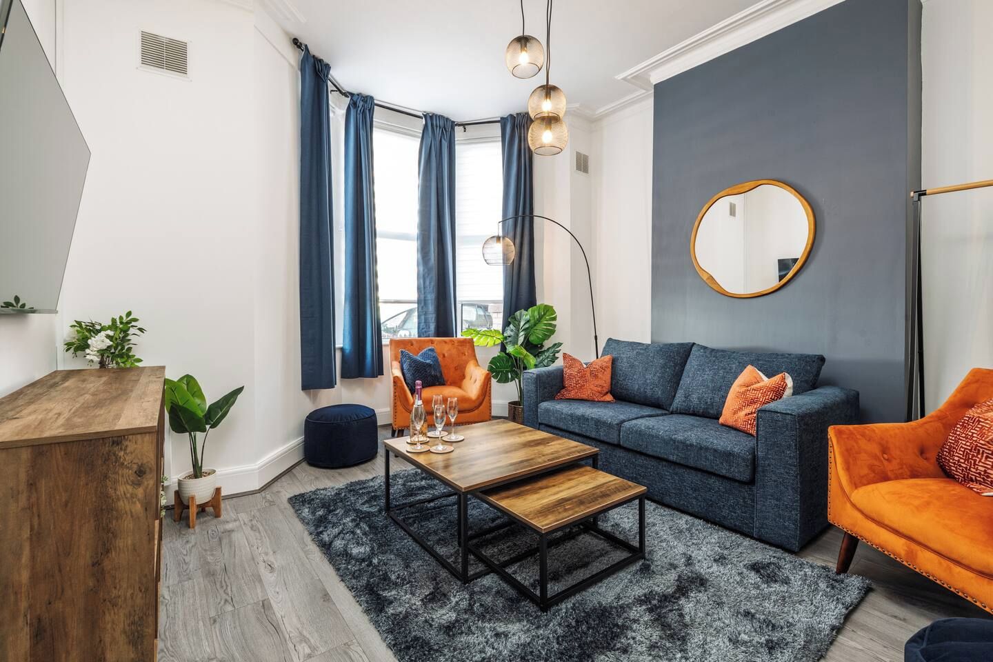 A modern living room with a sofa, coffee table, and a wooden side table.