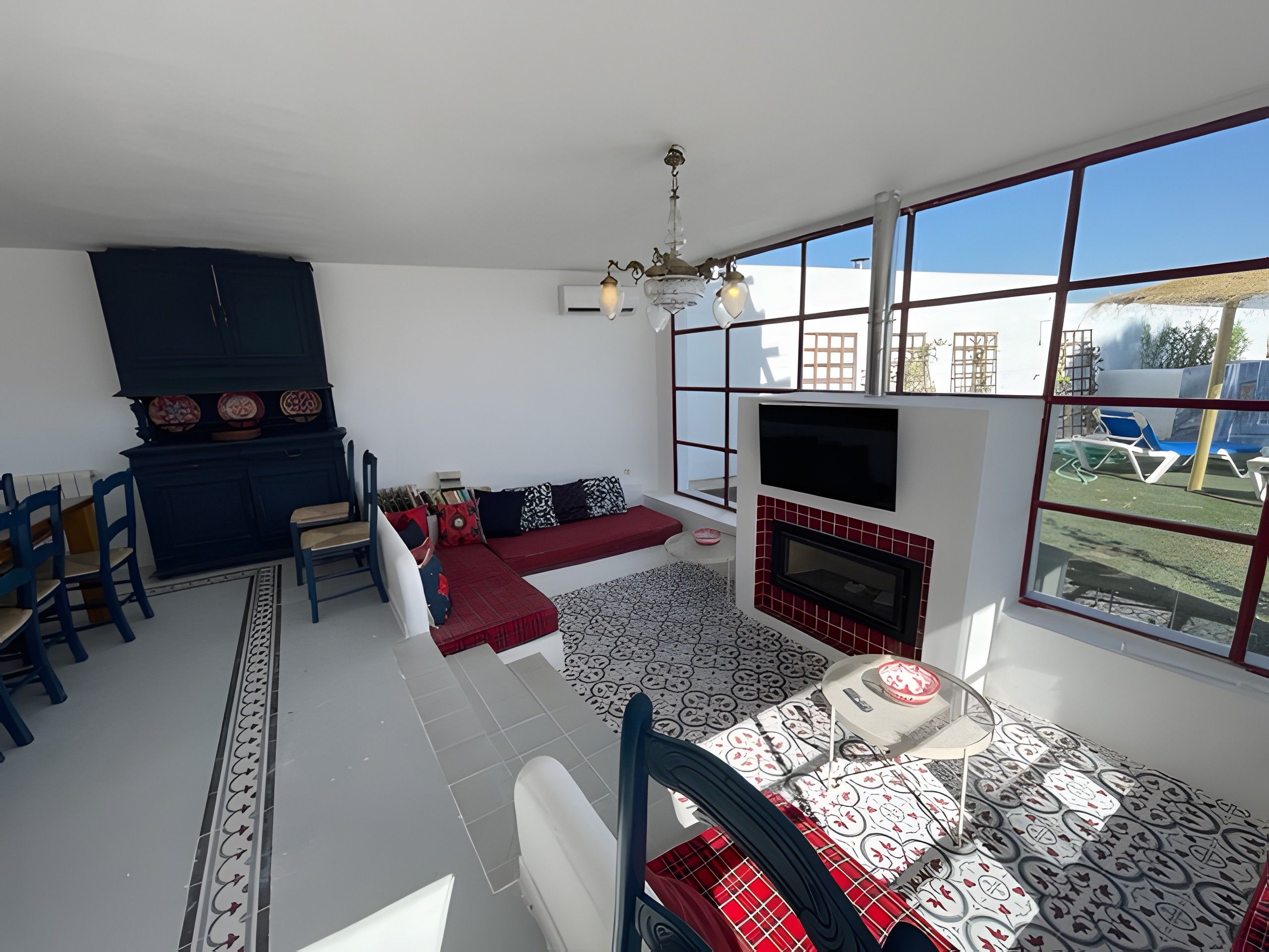 A living room with a sofa, chairs, a fireplace, and a TV.