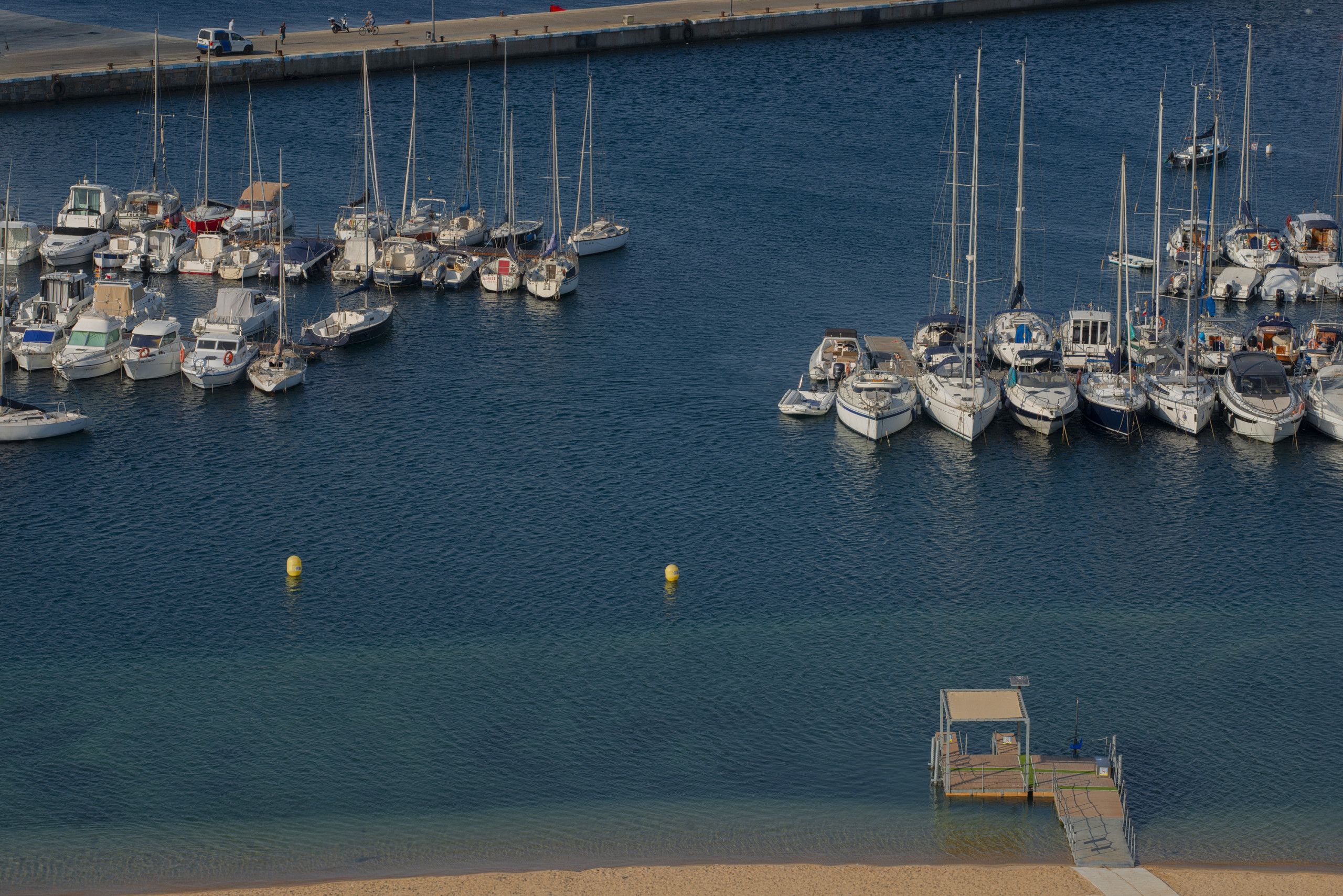 A marina with multiple boats docked.