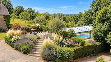 A garden with a chessboard, a bench, and a greenhouse.