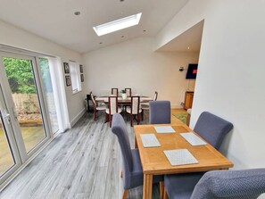 Bright and airy dining space set up and ready for your arrival. Gather round for a home-cooked meal - Kirkby Home | Hot Tub, Sauna & Games Room (Merseyside)
