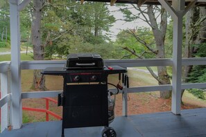 Een overdekt buitengebied met een barbecue.