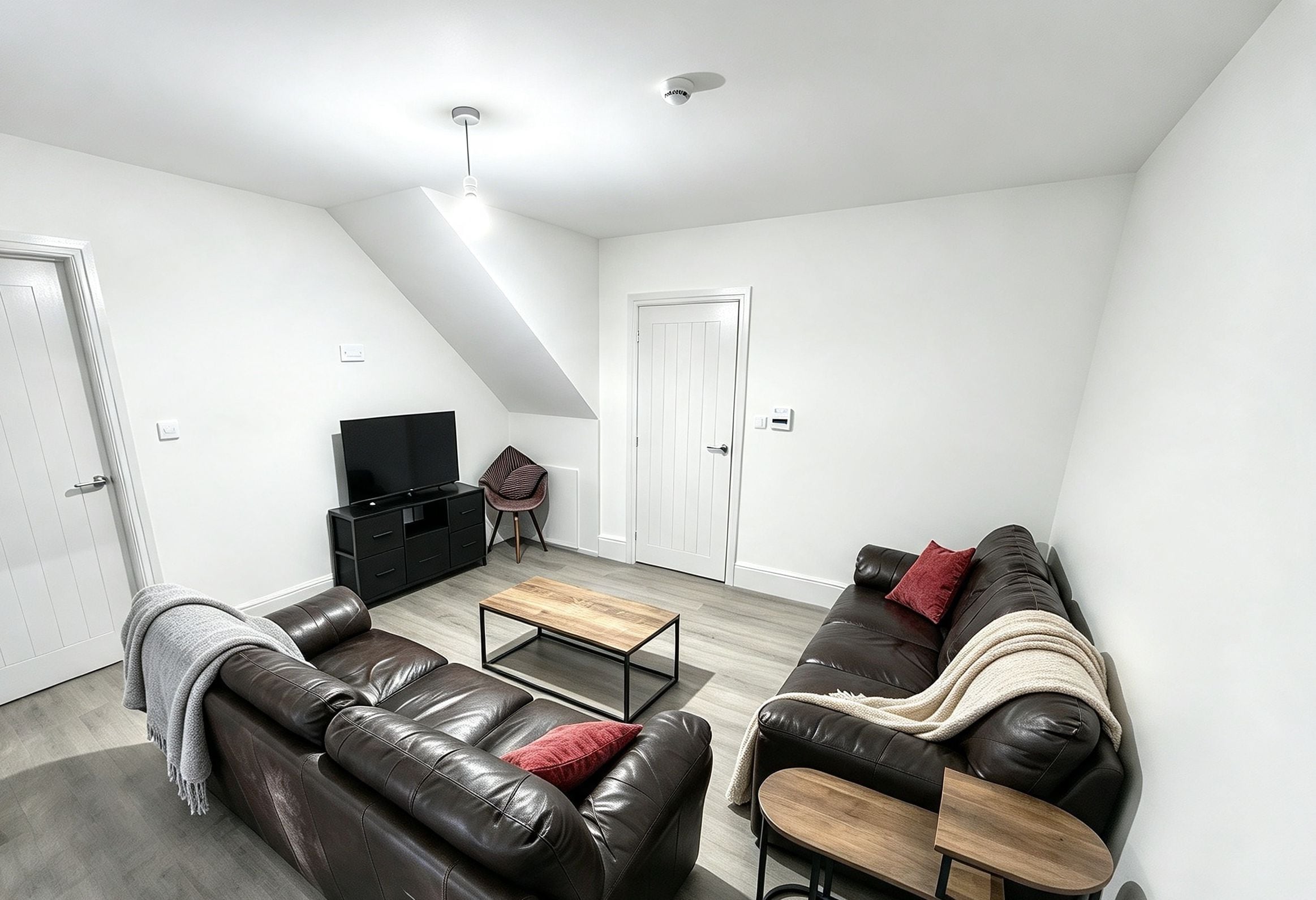 A modern living room with a sofa, a coffee table, and a television.