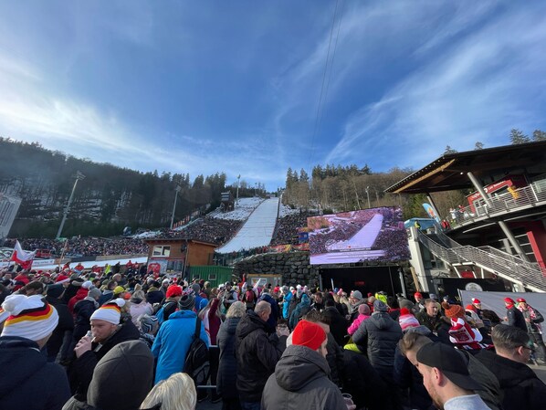 A crowded outdoor event with a large screen displaying an event. - Brandenburgs Holiday Apartment Sauerland Ostwig – Deluxe, 50 m² with Private Terrace (Bestwig)