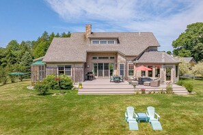 A two-story house with a patio, outdoor seating, and a covered area. - Spacious 4BR/4BA York Retreat w/ Big Backyard (York)