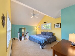 A bedroom with a bed, a ceiling fan, a lamp, and a view of the outside. - Spacious 4BR/4BA York Retreat w/ Big Backyard (York)