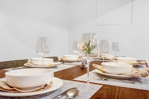 A dining table for six makes room for shared meals. - Private lower-level apartment near George Mason University. King bedroom, full kitchen, dining for six, workspace, and in-unit laundry. Sleeps five with a king sleeper sofa and twin sleeper chair. Private entrance and keypad self check-in. (Fairfax)
