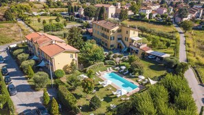 A residential property with a swimming pool, a covered patio, and a well-maintained garden. - New Listing (Lucca)
