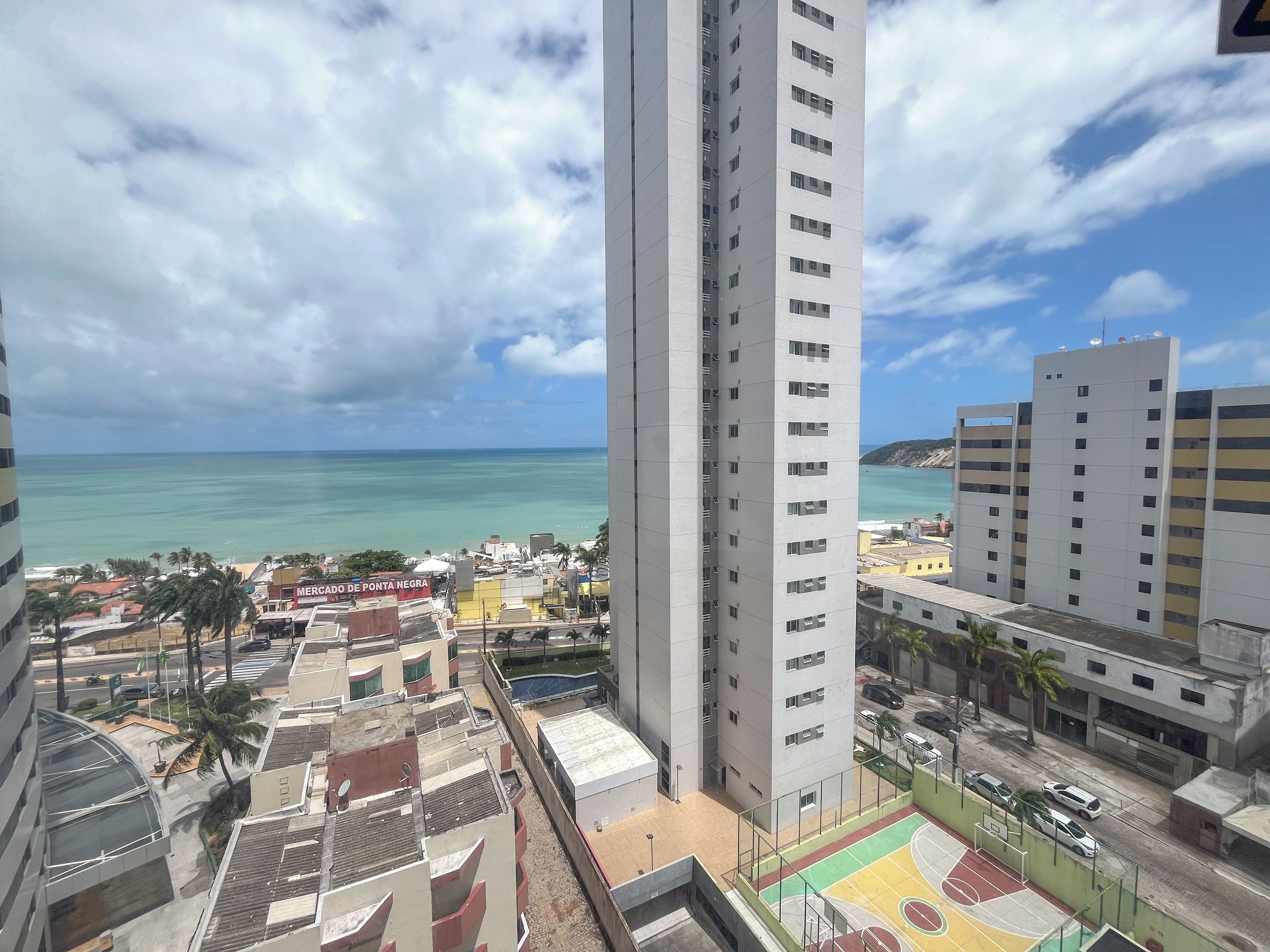 A high-rise building with a view of the beach and ocean.