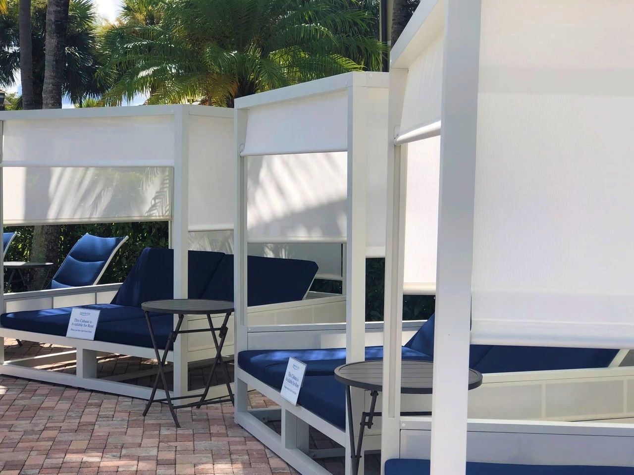 A poolside area with lounge chairs and a small table.