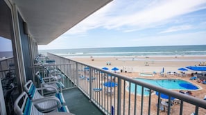 A balcony with a view of a beach and a swimming pool. - Beachside Getaway: Studio Starboard Villa at Sea Club IV by Capital Vacations (Daytona Beach Shores)