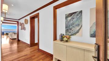 Elegant entryway with warm wood floors and artful island decor