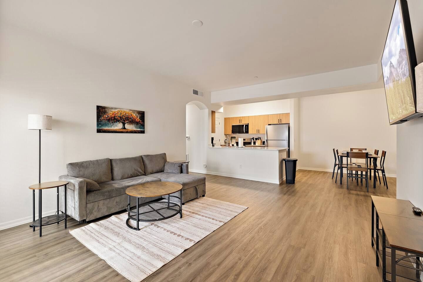 A modern living room with a sofa, coffee table, and floor lamp.