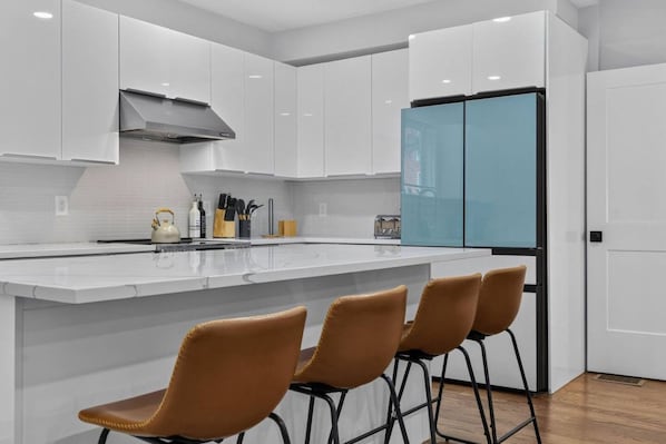 Quartz-topped kitchen island with additional prep space and seating
