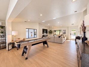A spacious living area with a pool table, sofas, and a television. - 19 Bds+Volleyball+Pickleball+Sauna+Cold Pl+Events (Indio)