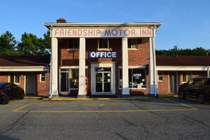 A building with a sign reading 'Friendship Motor Inn' and an 'Office' sign above the entrance.