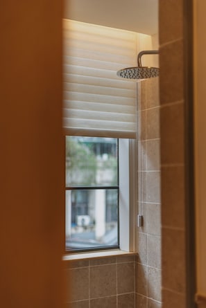 A bathroom with a shower, a window, and a view of the outside. - Hylla Casa (Chongqing)