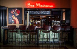 A bar with a neon sign, a menu board, and several leather bar stools. - Dream South Beach, by Hyatt | Pet-Alloweed | Nikki Beach Miami Beach - 0.9mi (Miami Beach)