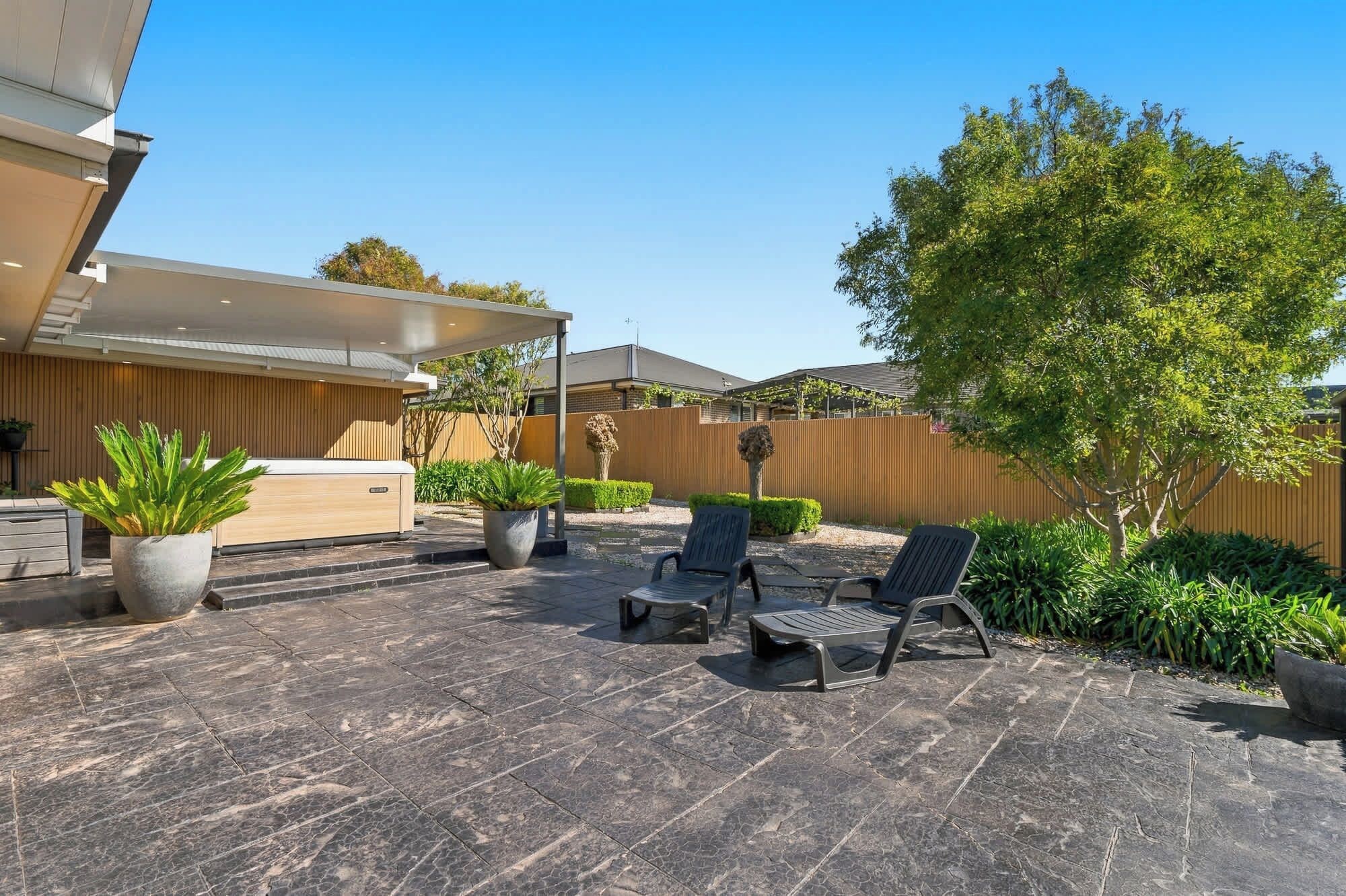 A patio area with outdoor seating, a reception desk, and a wooden fence.