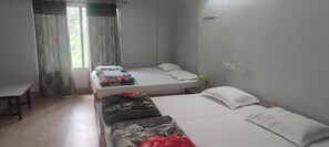 A room with two single beds, a bench, and a window with curtains. - Shantkunj (Uttarkashi)