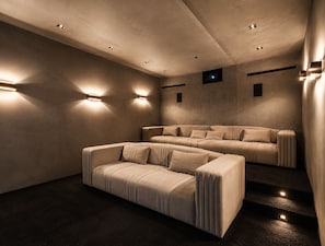 A modern cinema room with plush seating and ambient lighting. - Thrasher Aerie By Alora Reserve (Los Angeles)