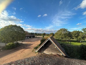 A rural property with a dirt driveway, a wooden structure, and a fenced area. - New Listing (Farges-Allichamps)