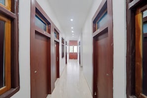 Un passadís amb portes i finestres de fusta, que condueix a una habitació amb vistes.