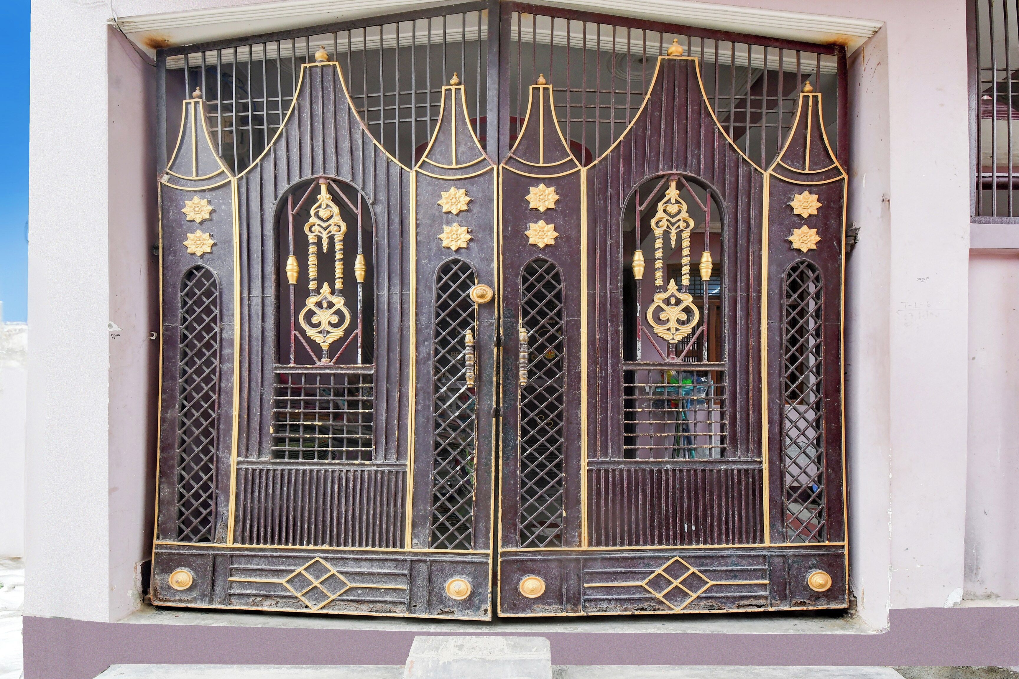 A double door with intricate metalwork and decorative elements.