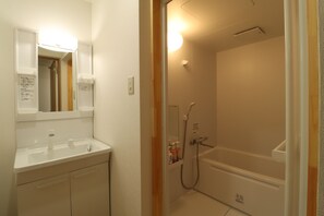 A bathroom with a sink, mirror, and a shower area. - Smart House Miduho (Kuma District Nishiki)