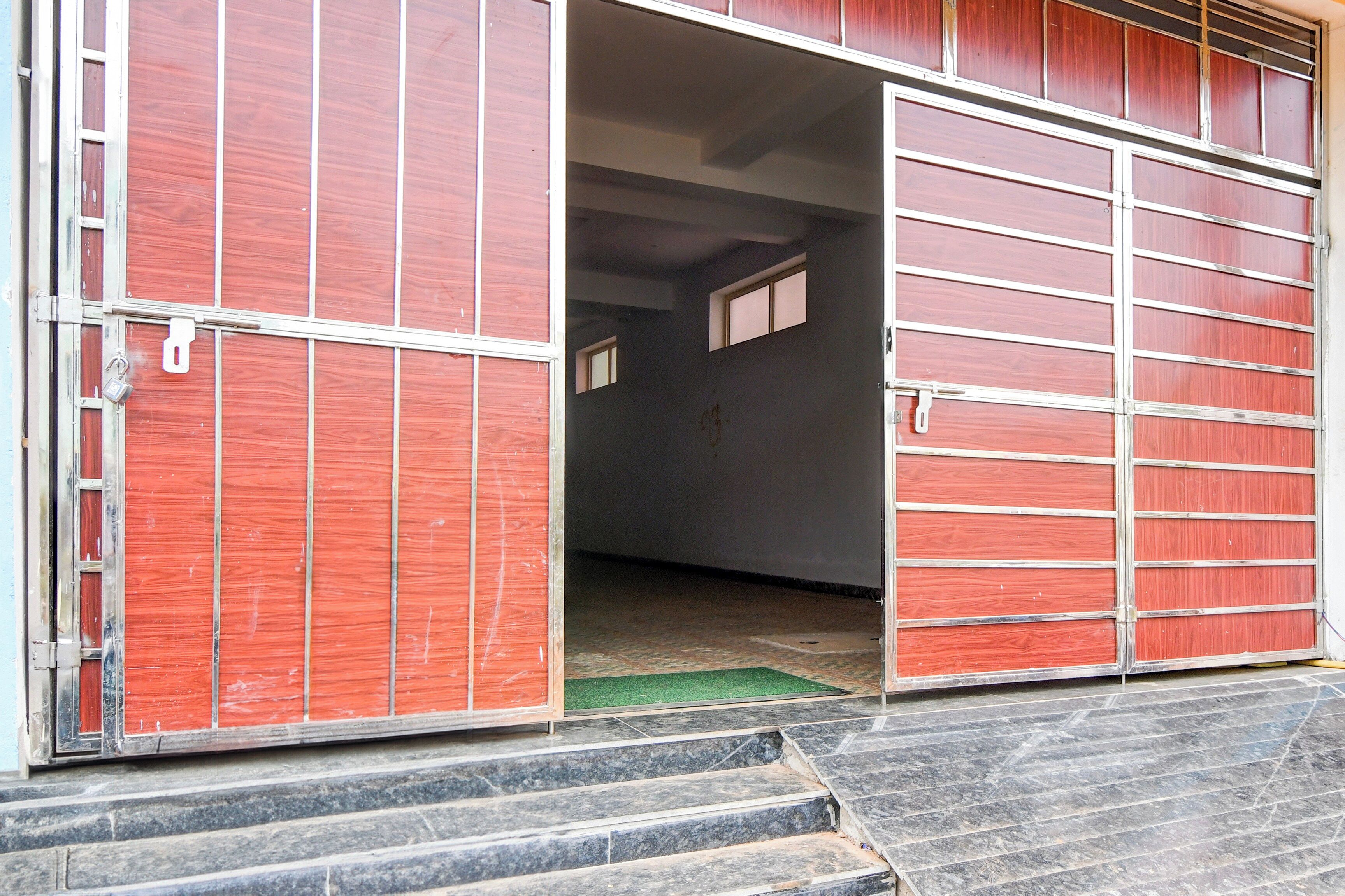 A garage door with a metal handle and a padlock.