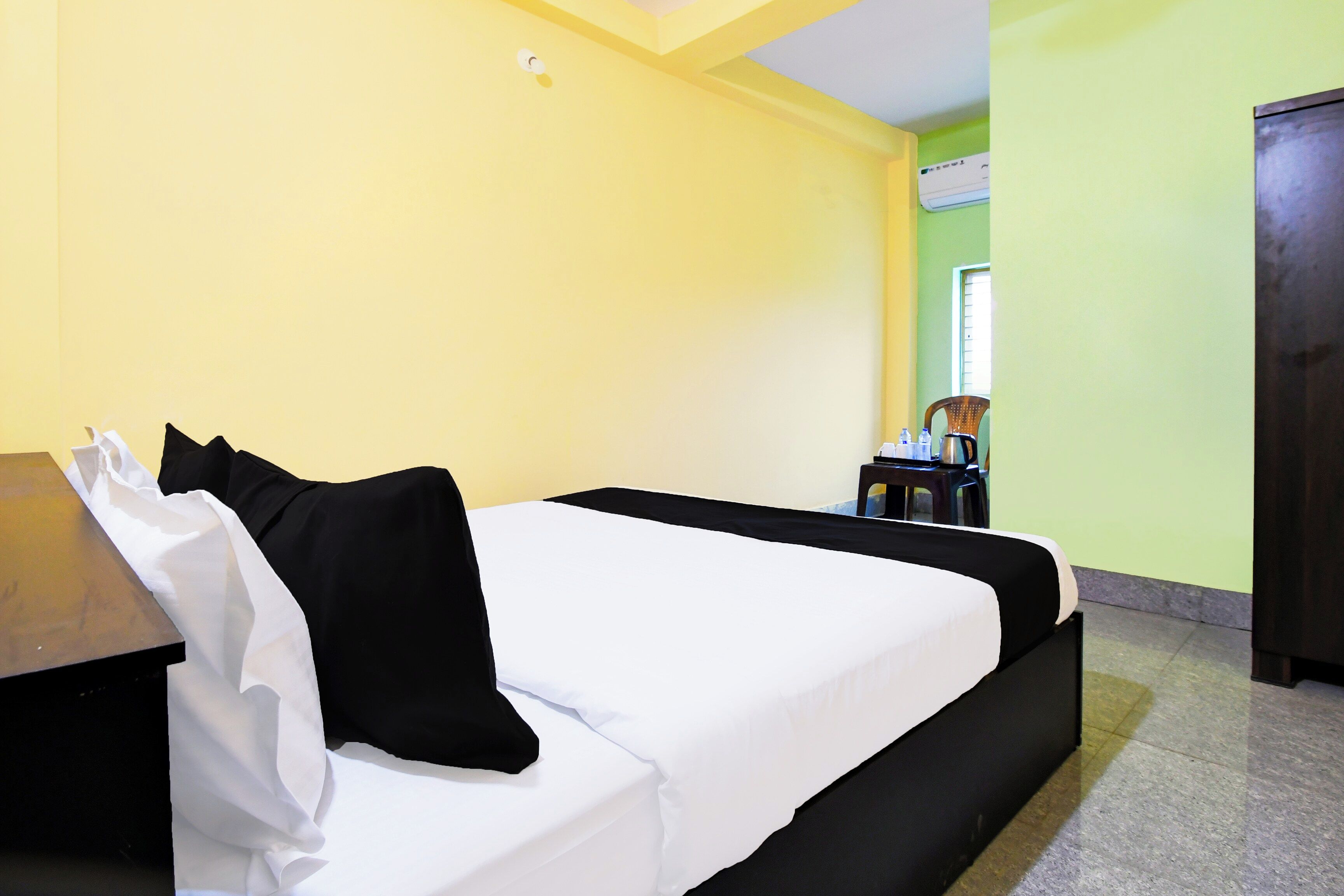 A room with a bed, a table, and a chair.