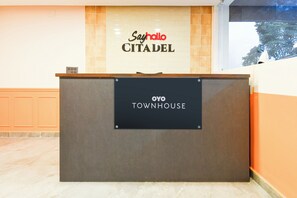 A reception desk with a sign reading 'Sayno Citadel' and 'OYO TOWNHOUSE'. - Hotel O Sayhallo Citadel (Bhubaneswar)