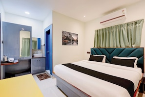A hotel room with a bed, a bathroom, and a view of the street. - Hotel O Sky Plex Guest House (Bhubaneswar)