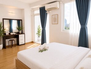 A hotel room with a bed, a desk, a chair, a mirror, and a window with curtains. - Spacious 2BR Apt near Ben Thanh Market & D1 Free Wifi (Thành phố Hồ Chí Minh)