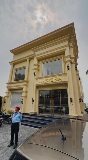 A building with a sign reading 'AMBROSIA' and a person standing in front.