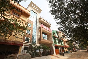 A multi-story building with a sign for 'Green Villa Guest House' on the second floor. - Hotel O Mahadev Palace (Bhubaneswar)