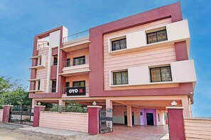 A multi-story hotel with balconies, a gated entrance, and a sign indicating 'Hotel Samrudhi Residency'. - Hotel O Samrudhi Residency (Bhubaneshwar)