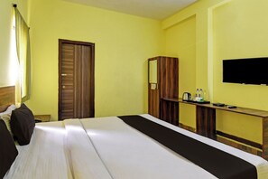 A hotel room with a bed, a desk, a television, and a wardrobe. - Hotel O Samrudhi Residency (Bhubaneshwar)