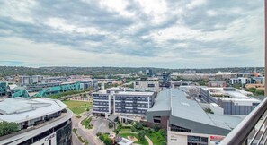 A cityscape with modern buildings, a clear sky, and a distant view of a hill. - Bigger Than Average 1-Bedroom (City of Tshwane Metropolitan Municipality)