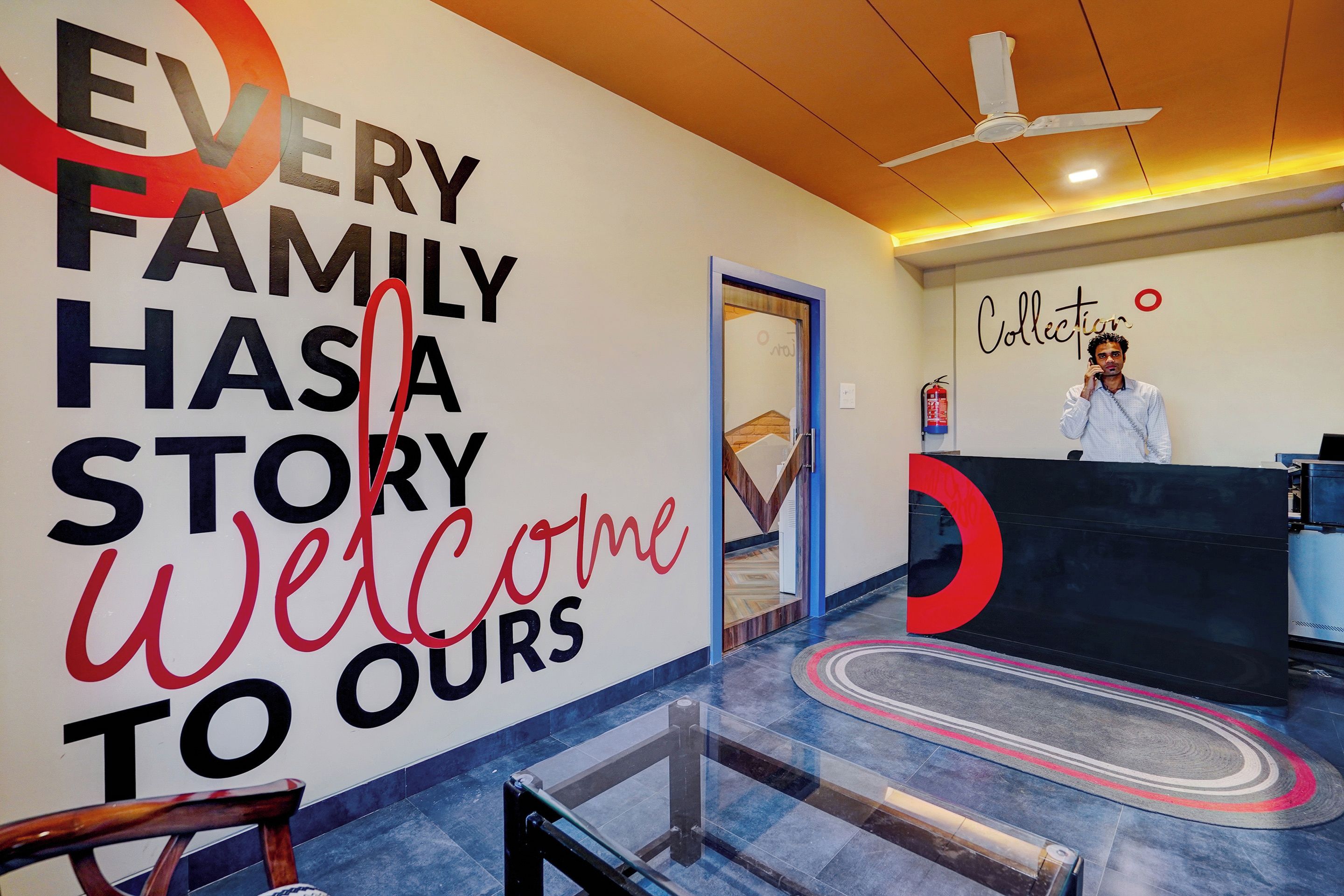 A reception area with a large wall sign that reads 'EVERY FAMILY HAS A STORY Welcome to Ours'.